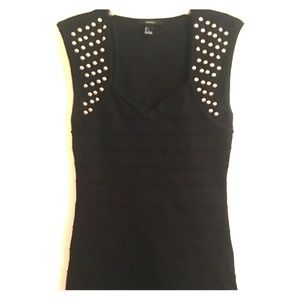 Short black form fitting club style dress.